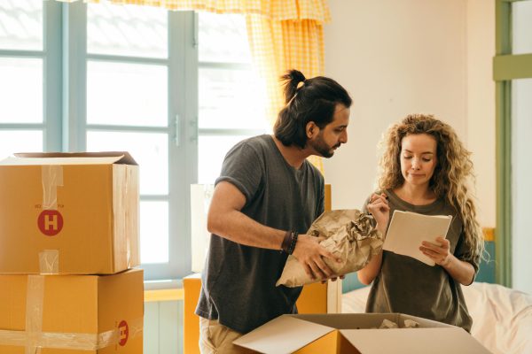 Man and woman pack belongings into boxes - visit rsd-storage.com